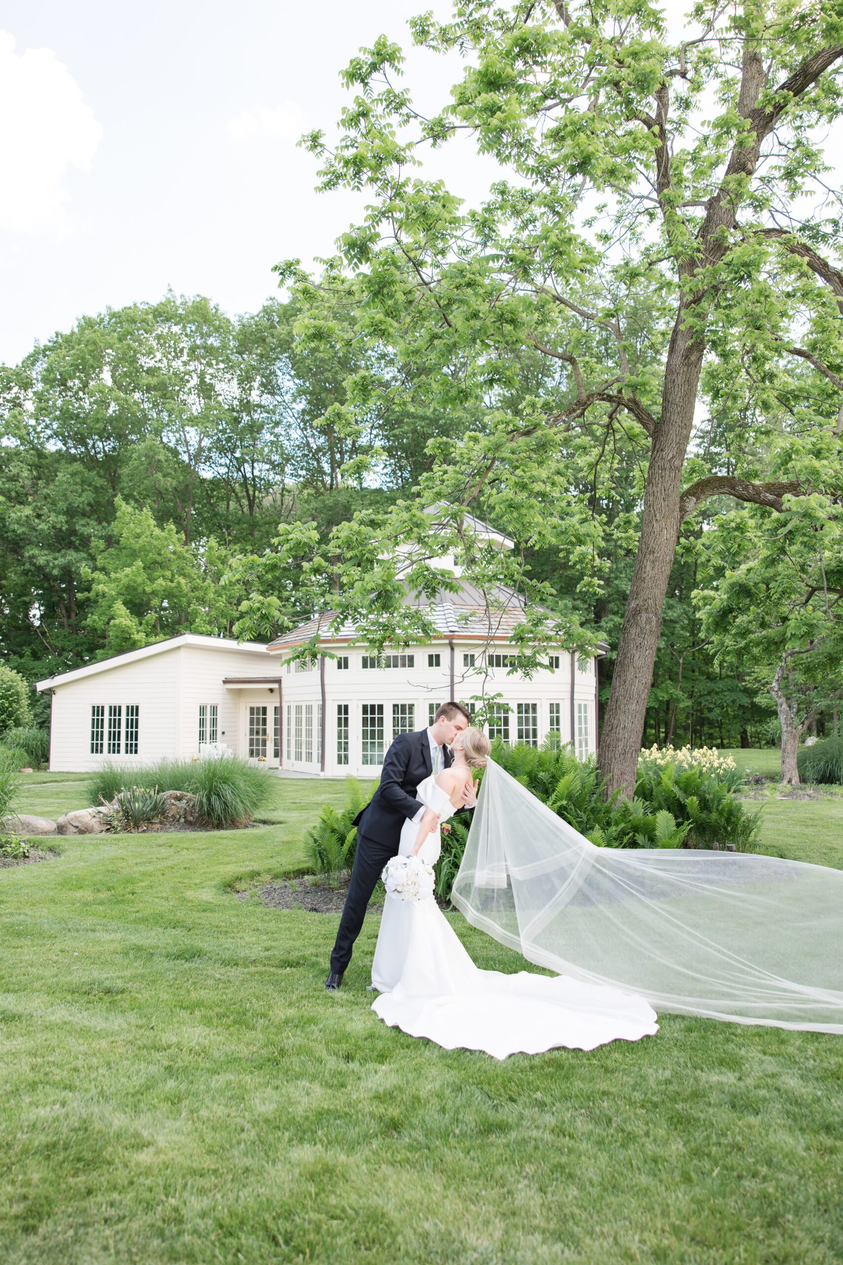 Bride and Groom dip kiss at Dempsey Event Center