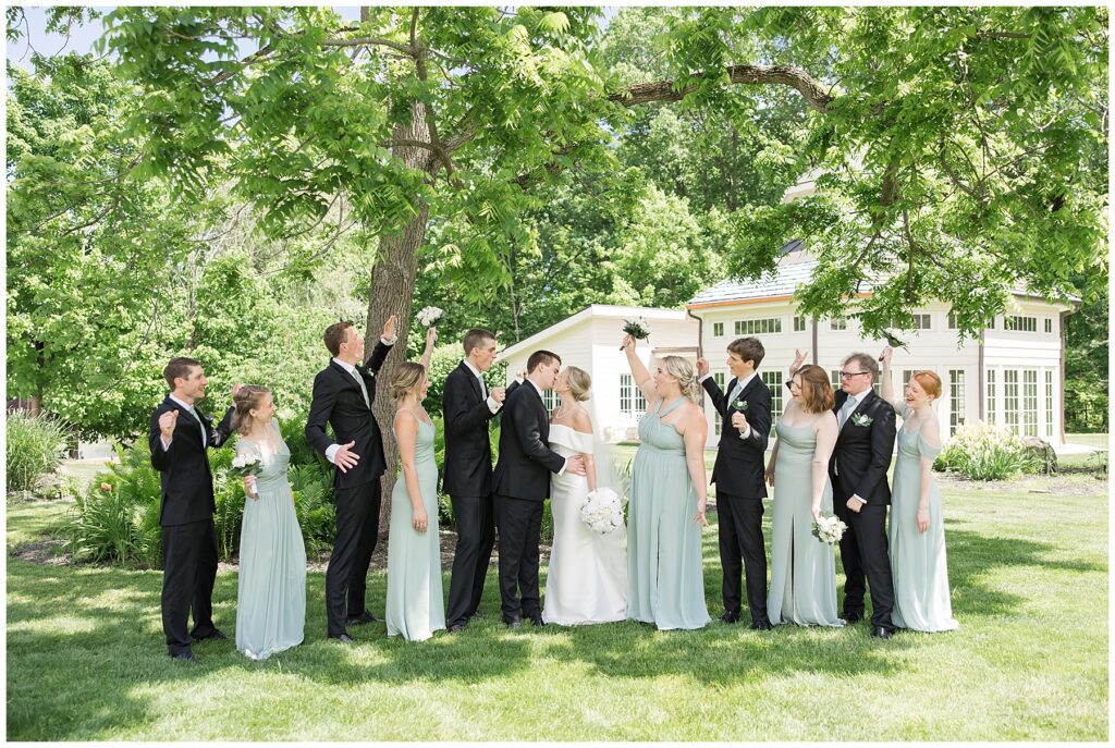 wedding party cheering as couple kisses at dempsey event center