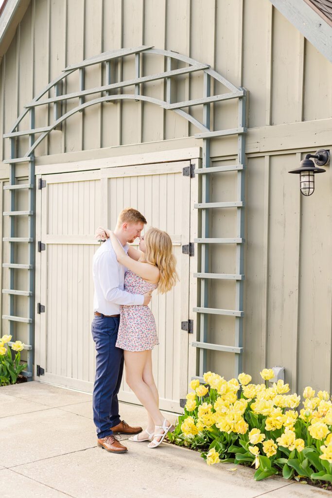 Franklin Park Conservatory Engagement Photo – A couple poses in front of the lush botanical gardens at Franklin Park Conservatory in Columbus, Ohio.